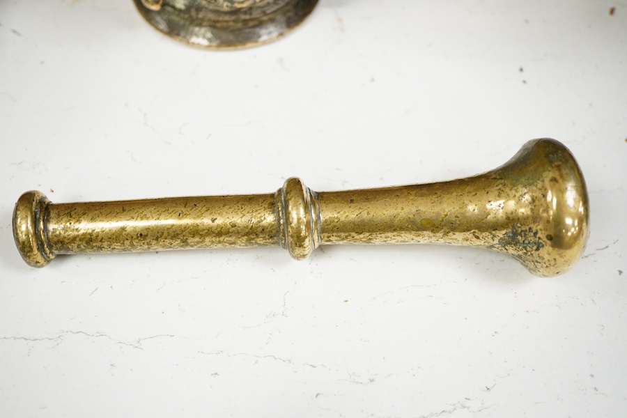 A bronze pestle and mortar, and one other mortar decorated in relief, 18cm in length
